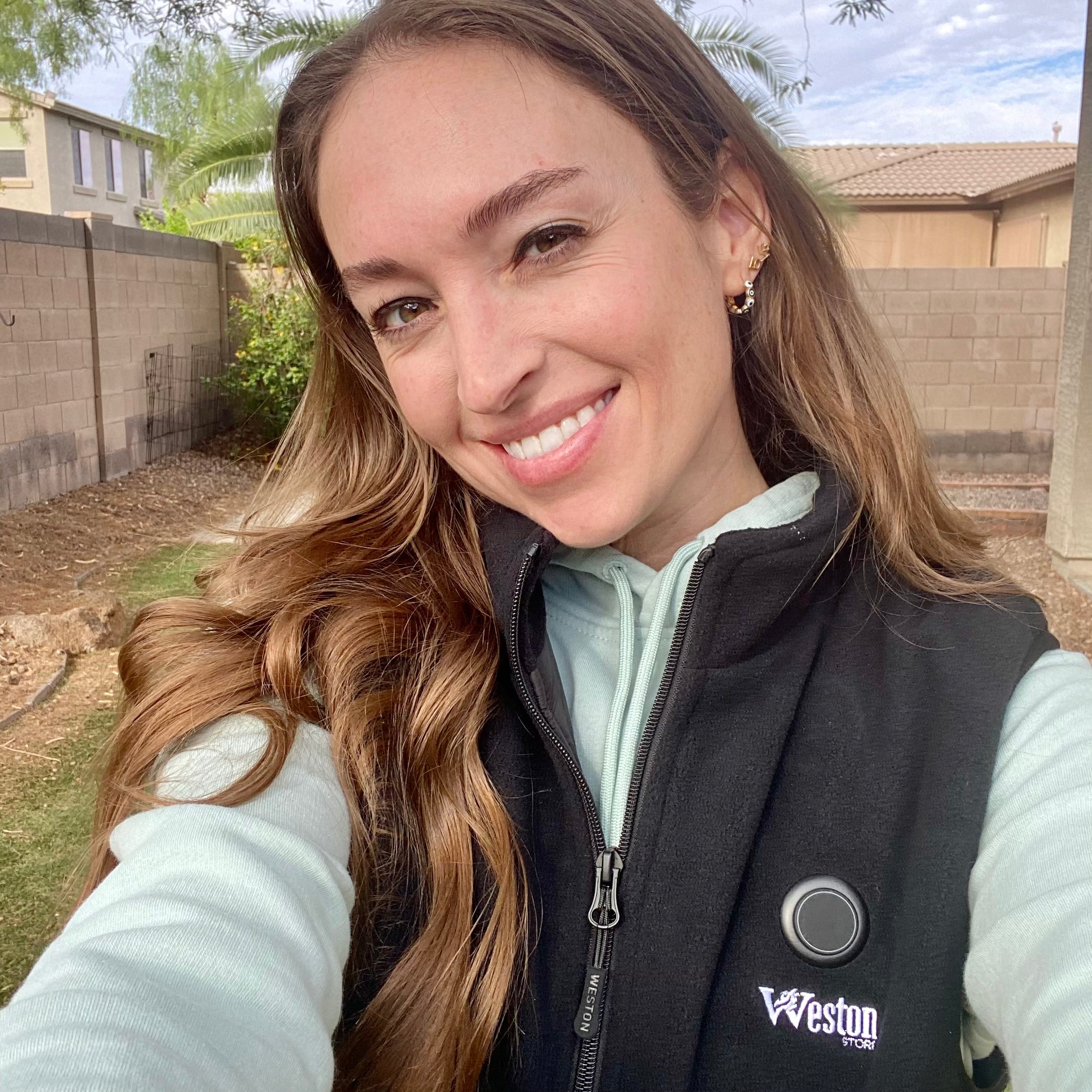 Heated fleece vest worn as an outdoor layer